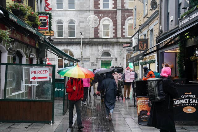 People walk through Cork city centre ahead of the General Election on Friday