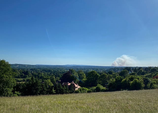 A fire on Thursley Common as seen from 11 miles away at Pewley Down park in Guildford