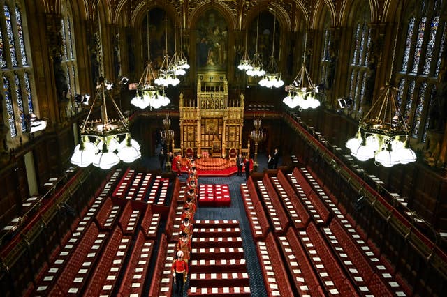 Yeoman of the Guard walk among the seats in the House of Lords Chamber during the State Opening of Parliament in the House of Lords, London