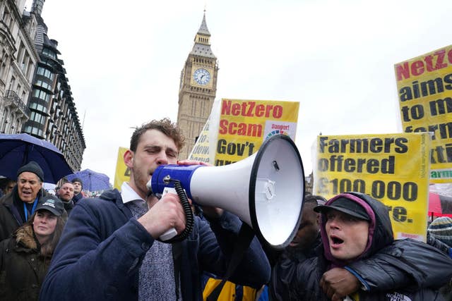 Farmers protest with signs and megaphones