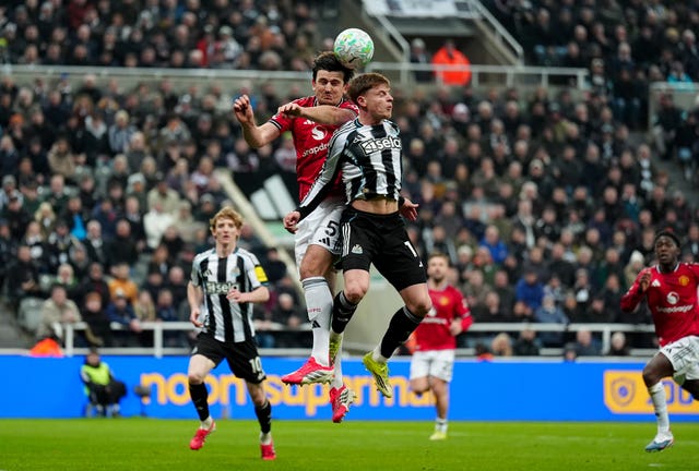 Manchester United’s Harry Maguire (left) and Newcastle’s Harvey Barnes battle for the ball