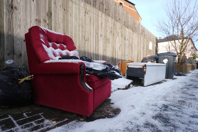 Uncollected refuse bags and household waste in the street