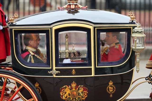 The Regalia: the Sword of State, the Imperial State Crown and the Cap of Maintenance are conveyed to the Palace of Westminster