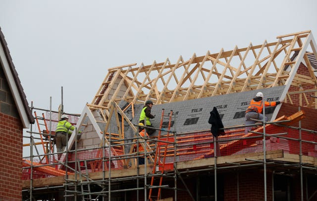 People working on the roof of a new home being built 