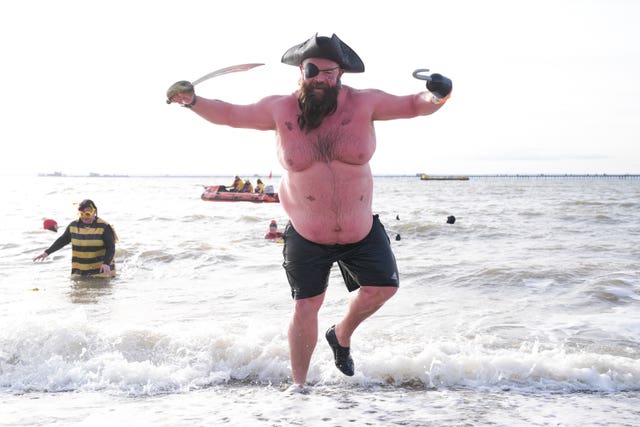 A man dressed as a pirate takes part in the RNLI New Year Day Dip in Southend-on-Sea, Essex