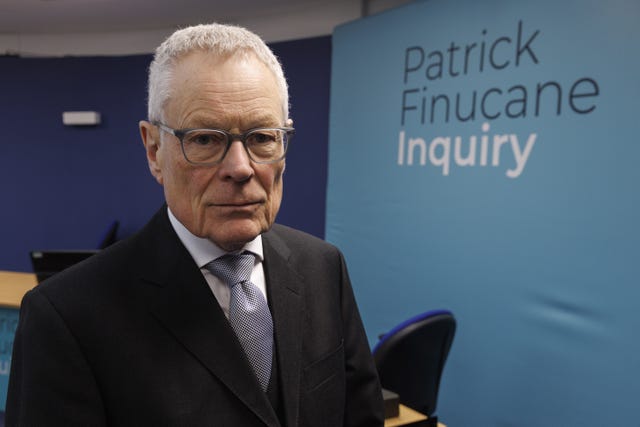 Sir Gary Hickinbottom in front of Pat Finucane Inquiry signage