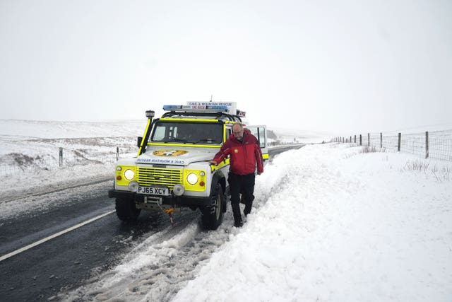 A member of a mountain rescue team after helping to clear cars from a snow drift near Ribblehead, in North Yorkshire