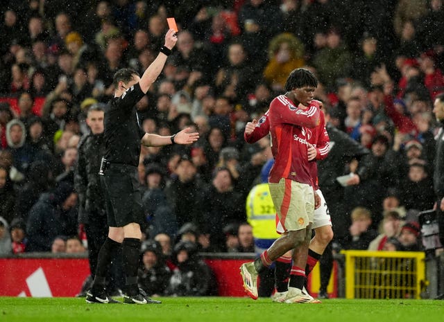 Patrick Dorgu turns to walk off as he is shown a red card by the referee