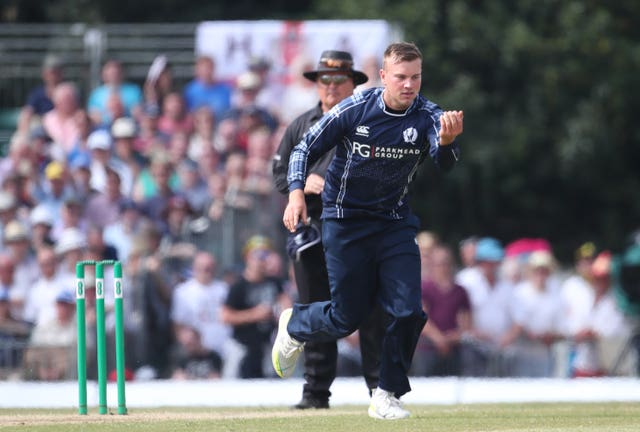 Scotland spinner Mark Watt celebrates the wicket of England's Jason Roy.