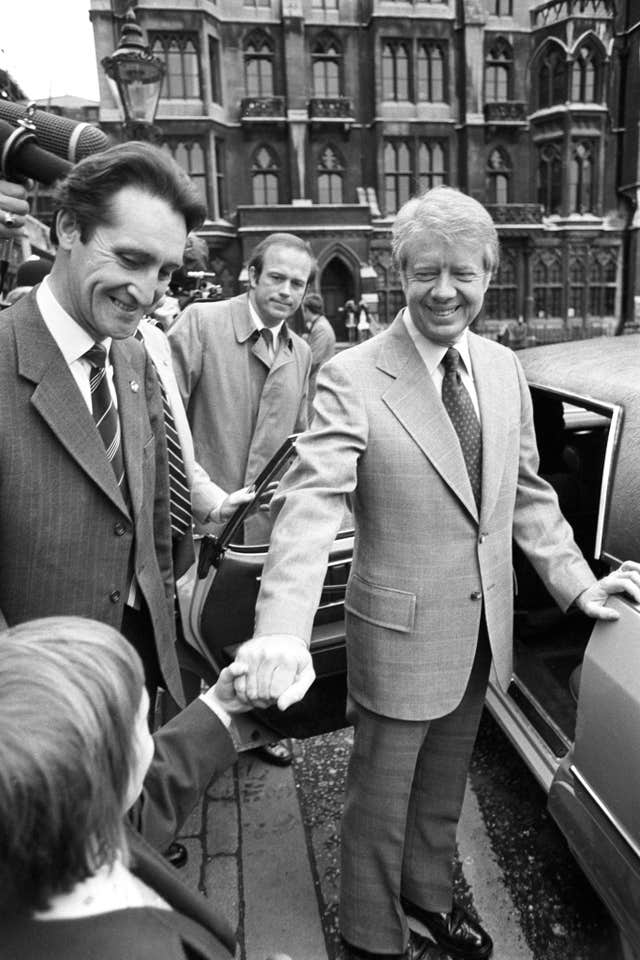 Jimmy Carter shakes a boy's hand.