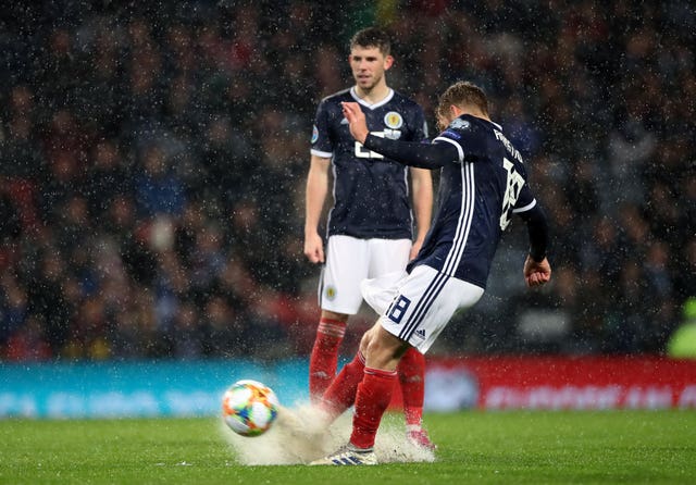Stuart Armstrong scores Scotland's sixth amid heavy rain
