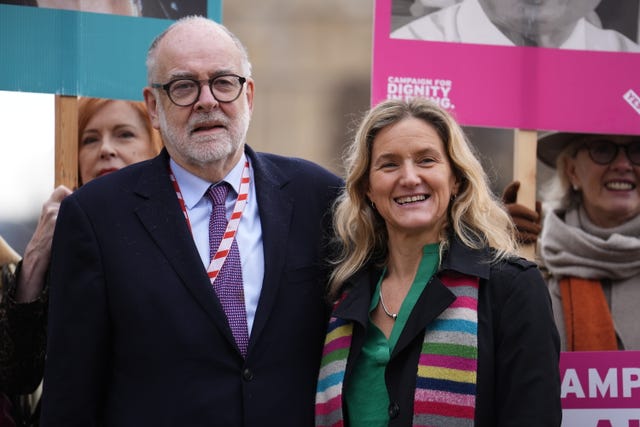 Lord Falconer and Kim Leadbeater, who is smiling, standing amongst assisted dying supporters