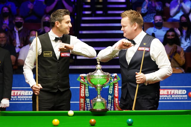 Mark Selby (left) and Shaun Murphy bump elbows before the start of the Betfred World Snooker Championships final