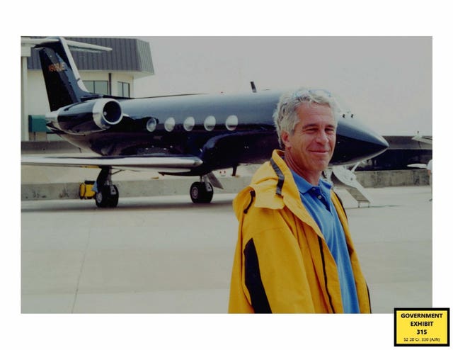 Jeffrey Epstein standing in front of a plane