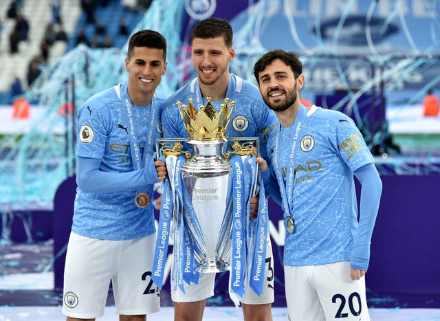 Joao Cancelo (left) pictured with the Premier League trophy