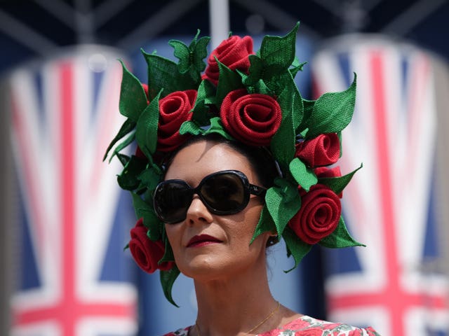 A woman wears a hat meant to resemble roses