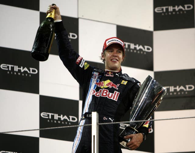 Sebastian Vettel celebrates with the trophy and a bottle of champagne after victory in the 2009 Abu Dhabi Grand Prix