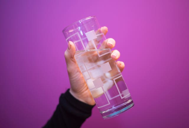 A person holding a glass of water