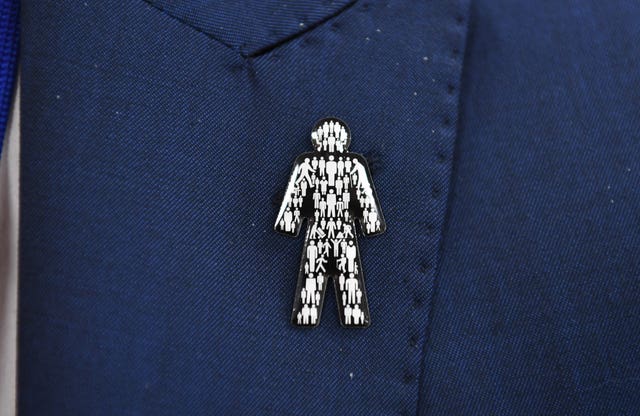 A Men pin badge (Simon Galloway/PA)