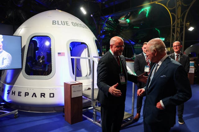 The King views a replica of Blue Origin’s New Shepard, a fully reusable suborbital rocket system