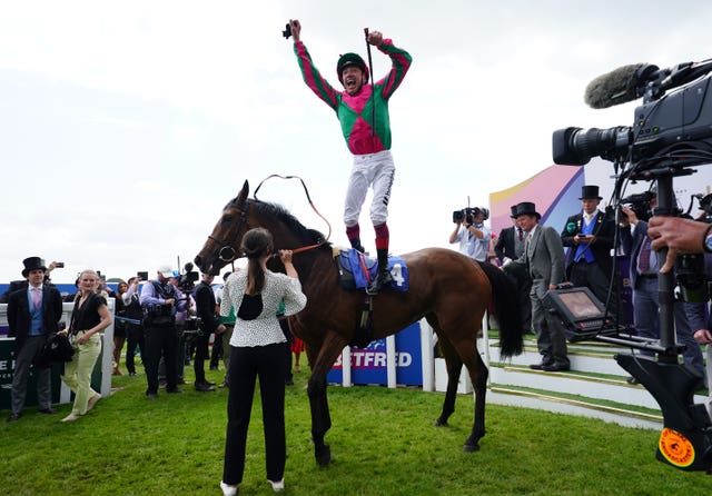 Jockey Frankie Dettori performs a flying dismount from Prosperous Voyage after winning The Princess Elizabeth Stakes 