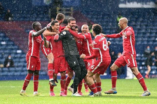 Liverpool goalkeeper Alisson Becker is mobbed by his team-mates