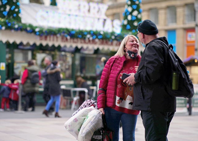 Christmas shoppers walk through the centre of Cardiff, Wales, where people have been told to prepare for more restrictions in the coming weeks as the country faces an impending “tsunami” from the Omicron variant of Covid-19. 