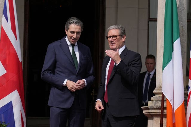 Taoiseach Simon Harris greets Sir Keir Starmer outside Farmleigh House