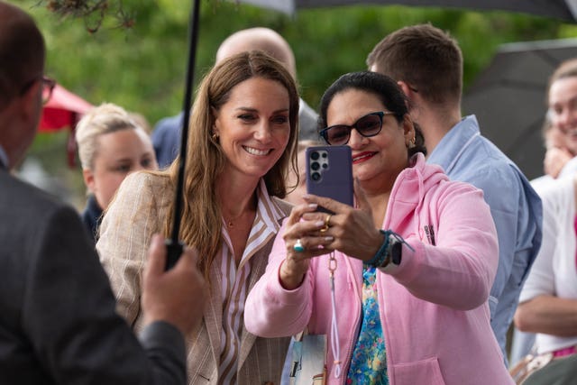 The Princess of Wales takes a selfie with a member of the public during her visit