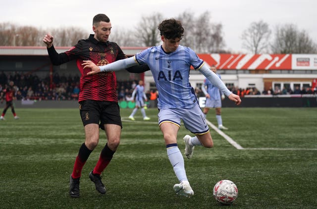 Tamworth’s Thomas McLinchey (left) and Tottenham’s Archie Gray battle for the ball