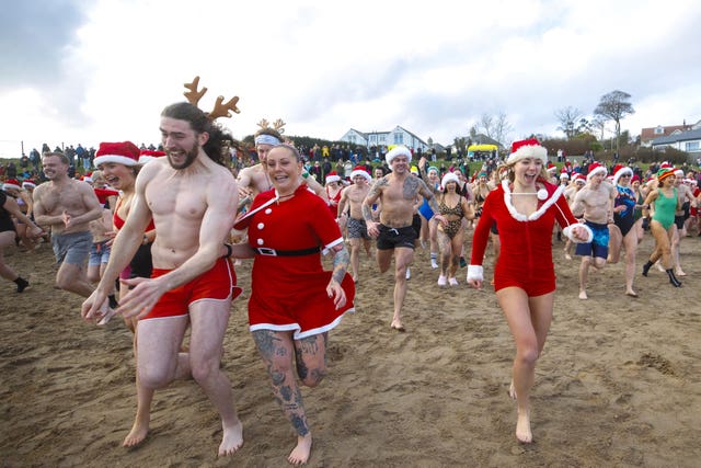 People running into the water at Helen’s Bay