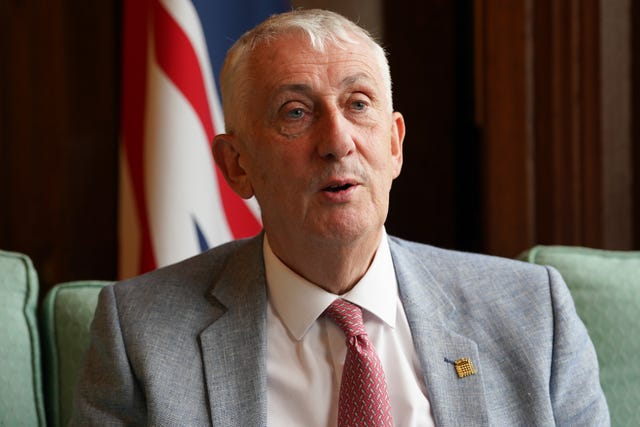 Sir Lindsay Hoyle sitting in front of a Union flag