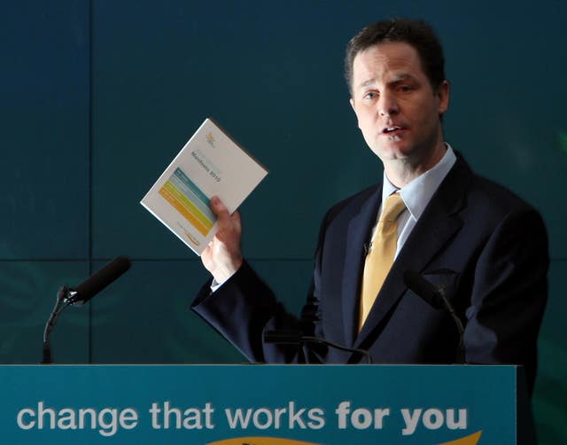 Nick Clegg holding a copy of the Lib Dems 2010 election manifesto