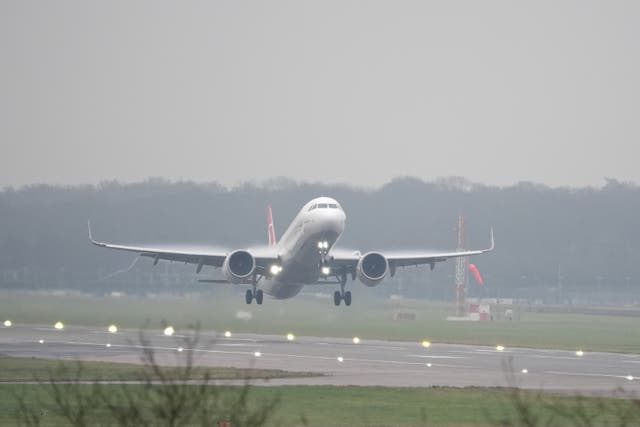 A plane takes off in foggy conditions from London Gatwick airport in Crawley, West Sussex. 