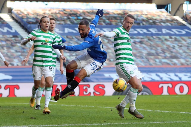 Kemar Roofe, centre, goes down under the challenge of Leigh Griffiths, right