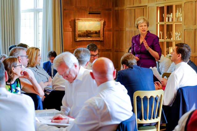 Brexit Secretary David Davis stares at his notes as Theresa May speaks, while Penny Mordaunt watches on, arms folded (Joel Rouse/Crown Copyright/PA)