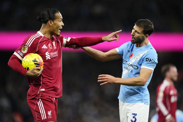 Virgil van Dijk (left) attempts to keep the ball from Manchester City’s Ruben Dias 