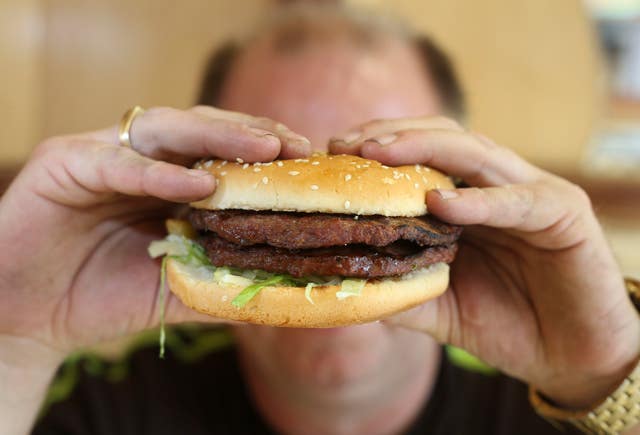 A generic stock photo of a half-pounder burger and chips in a takeaway carton.