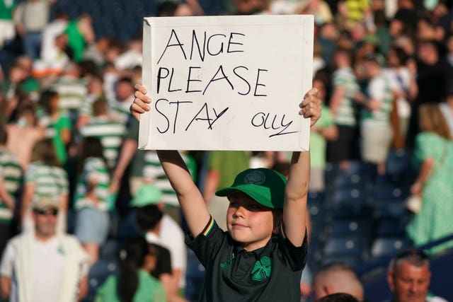 A young Celtic fan holds up a sign at Hampden on Saturday
