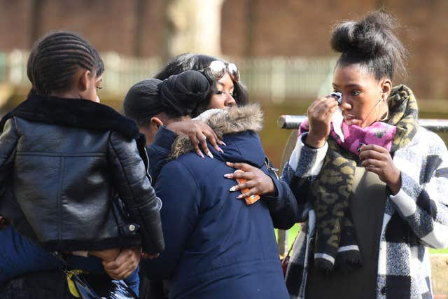 People pay their respects at the scene in Link Street, Hackney (Stefan Rousseau/PA)