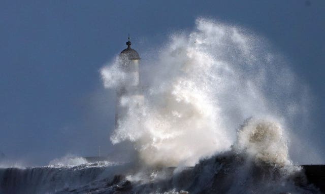 Big waves hit the lighthouse at Seaham in Durham