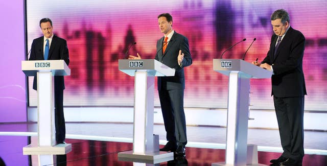 David Cameron, Nick Clegg and Gordon Brown standing behind podiums in the final TV debate of the 2010 general election