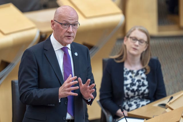 John Swinney speaking from the front bench of the Holyrood debating chamber