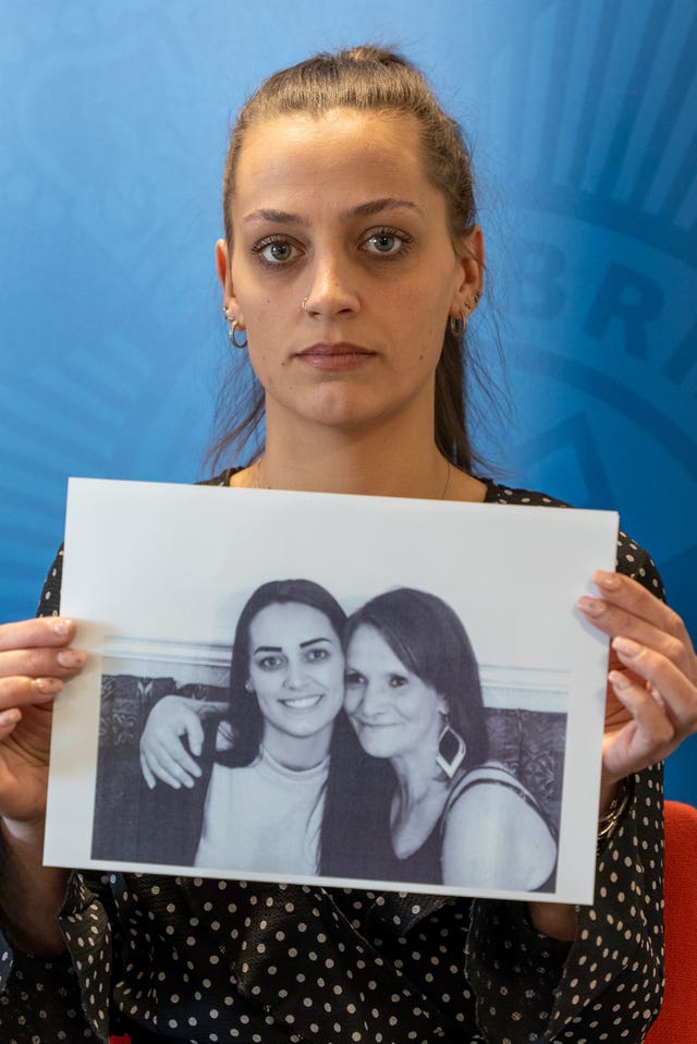 Shannon Brown holding a photograph of herself with her mother, right, Michelle Hanson