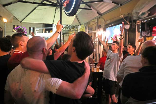Liverpool fans celebrate the final whistle in a bar in Rome city centre (Steve Parsons/PA)