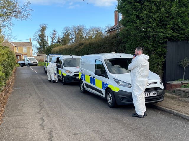 Police forensics officers in The Row in Sutton