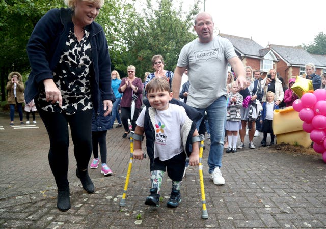 Tony Hudgell, who uses prosthetic legs, takes the final steps in his fundraising walk in West Malling Kent, with mum, Paula and dad Mark. Five-year-old Tony has raised more than �1,000,000 for the Evelina London Children’s Hospital, who have cared for him since he was four-months-old, by walking every day in June, covering a distance of 10 kilometres