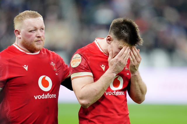 Wales’ Josh Adams (right) holds his head in his hands