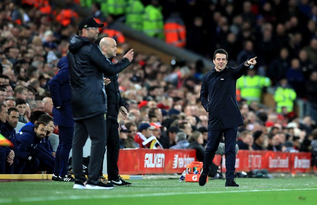 Jurgen Klopp, left, says he apologised to Everton manager Marco Silva, right, on Sunday