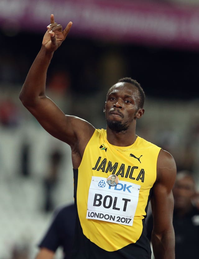 Usain Bolt, in a yellow Jamaica kit, waves to the crowd 